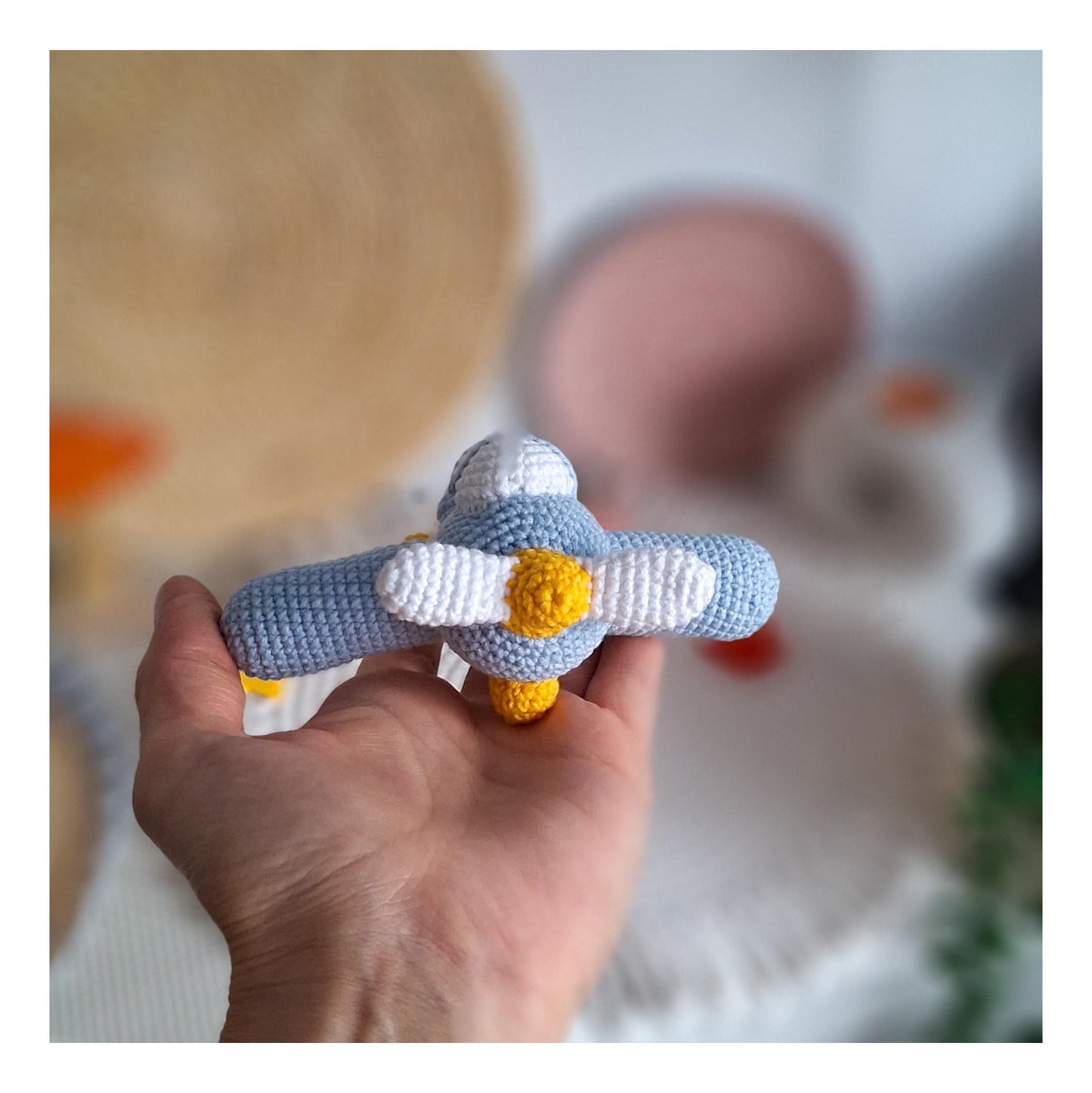 Crochet aircraft keychain photographed on wooden background