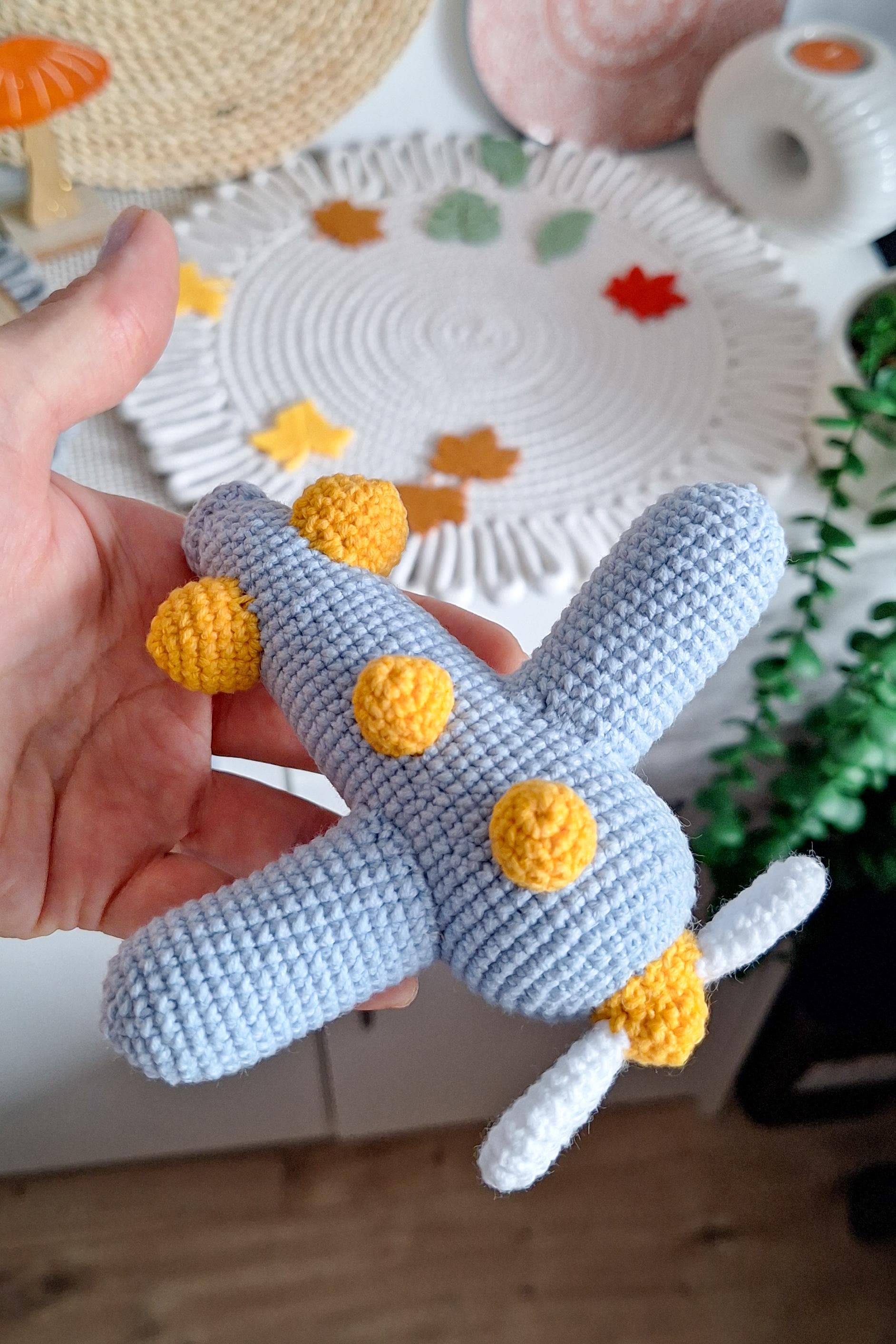 Small crochet airplane toy with decorative bead eyes