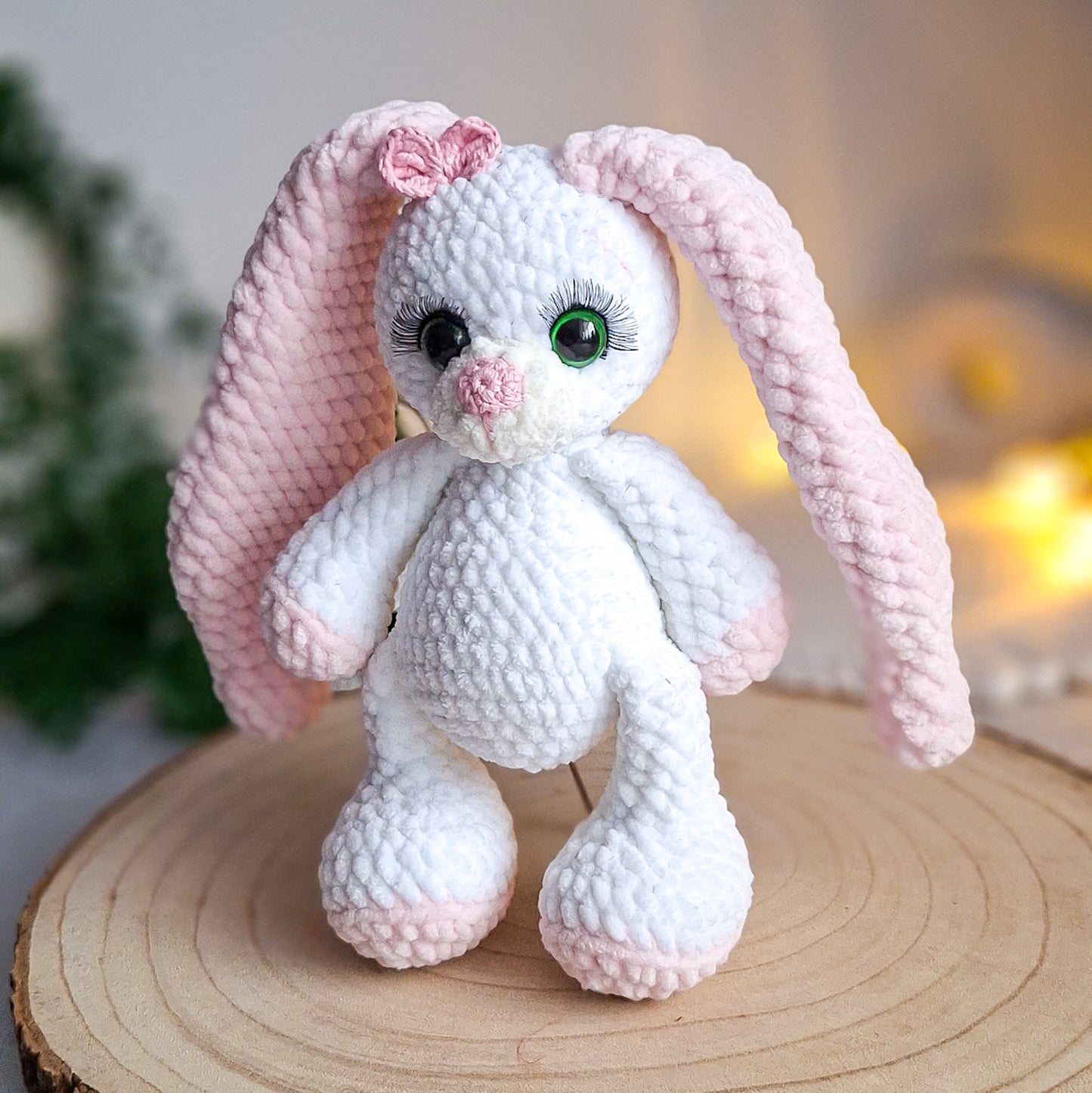 Long eared crochet bunny sitting on a wooden surface